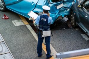 Police officer filing a report after a car accident