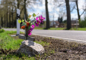 Roadside memorial flower arrangement next to scene of a fatal car accident