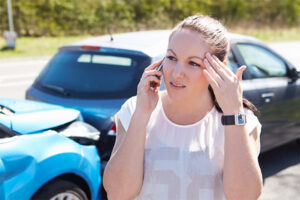 Woman in car accident on phone because car insurance lapsed